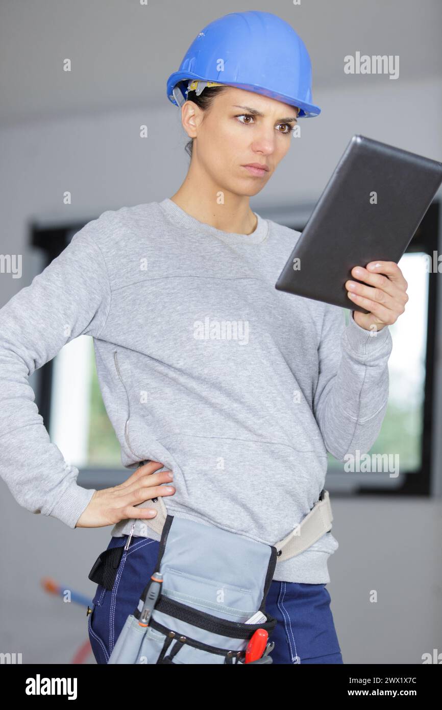 female construction worker watching tablet Stock Photo