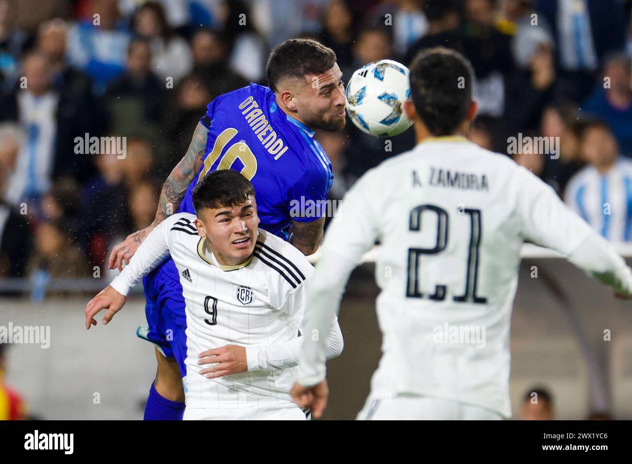 Los Angeles, United States. 26th Mar, 2024. Argentina's Nicolas Otamendi (C) and Costa Rica's Manfred Alonso Ugalde Arce (L) in action during an international friendly soccer match at Los Angeles Memorial Coliseum. Final score; Argentina 3:1 Costa Rica Credit: SOPA Images Limited/Alamy Live News Stock Photo