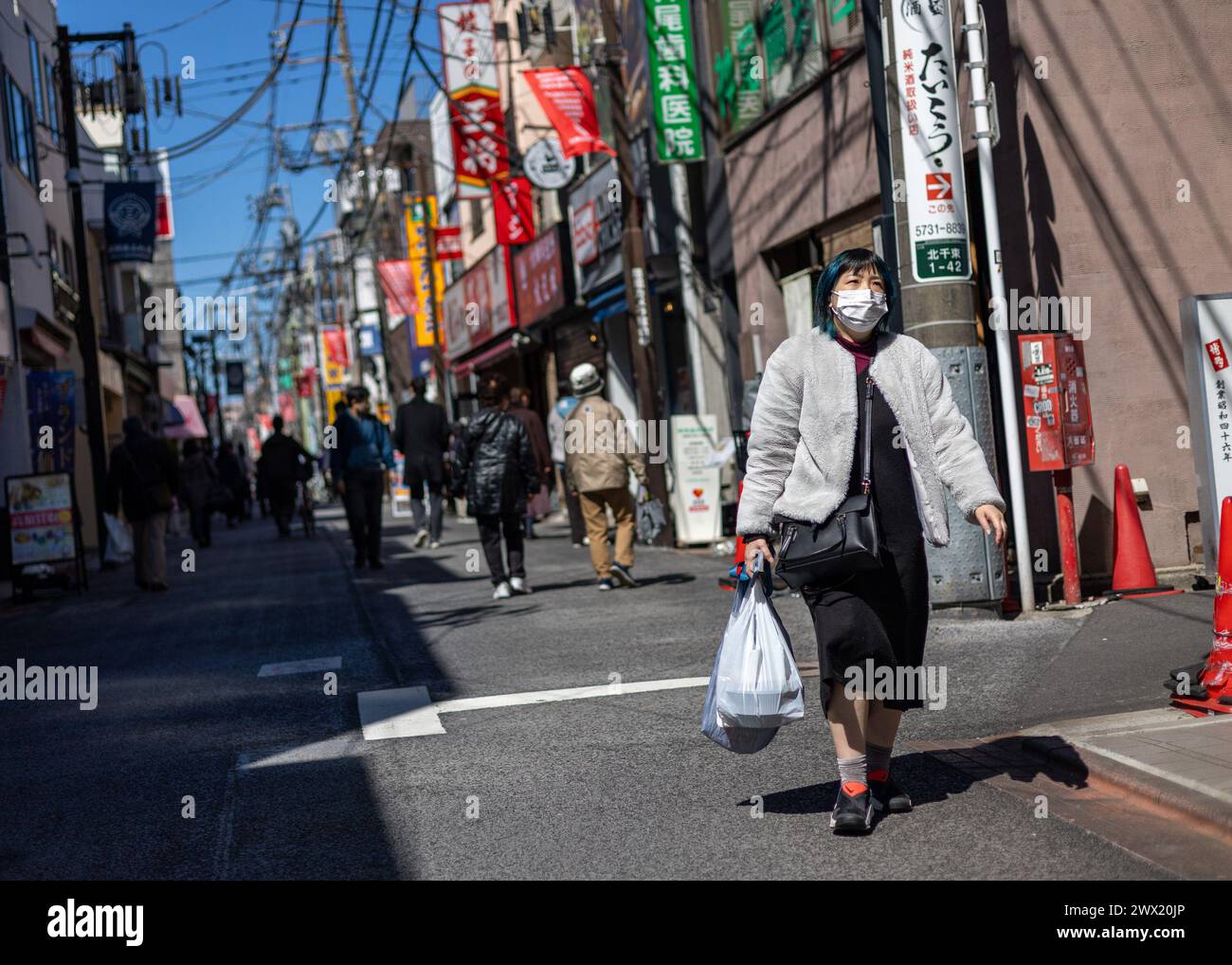 Tokyo, Japan. 27th Mar, 2024. Members of the public enjoy sunny weather