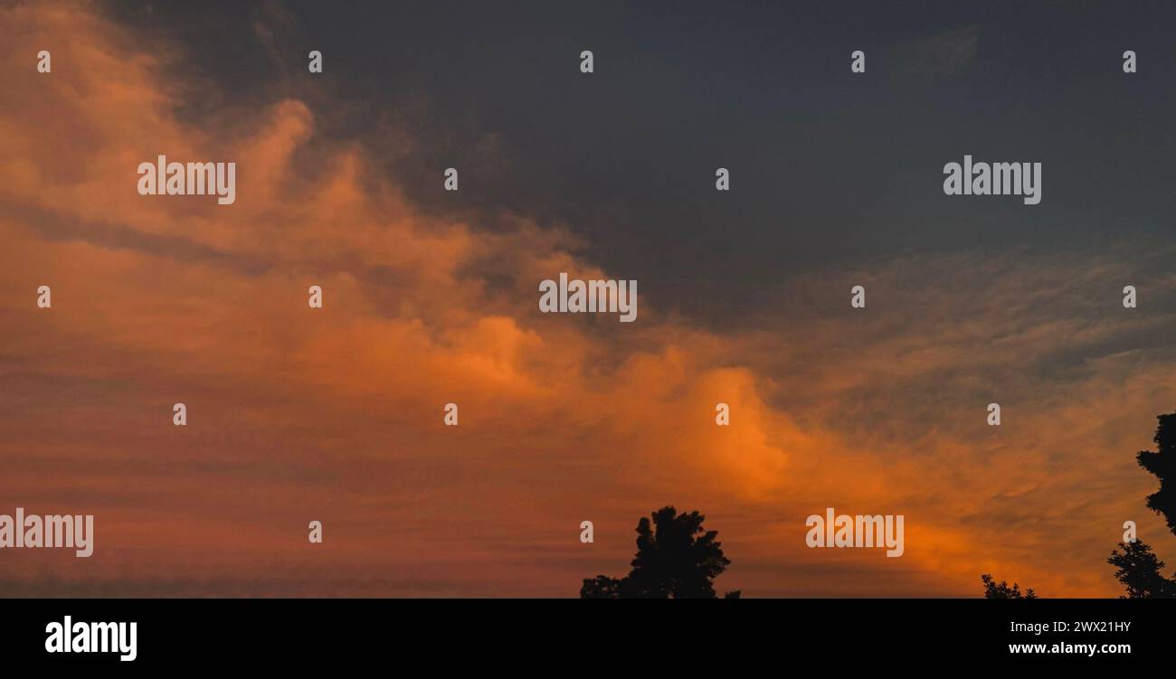 A dramatic sunset sky with fluffy clouds Stock Photo - Alamy