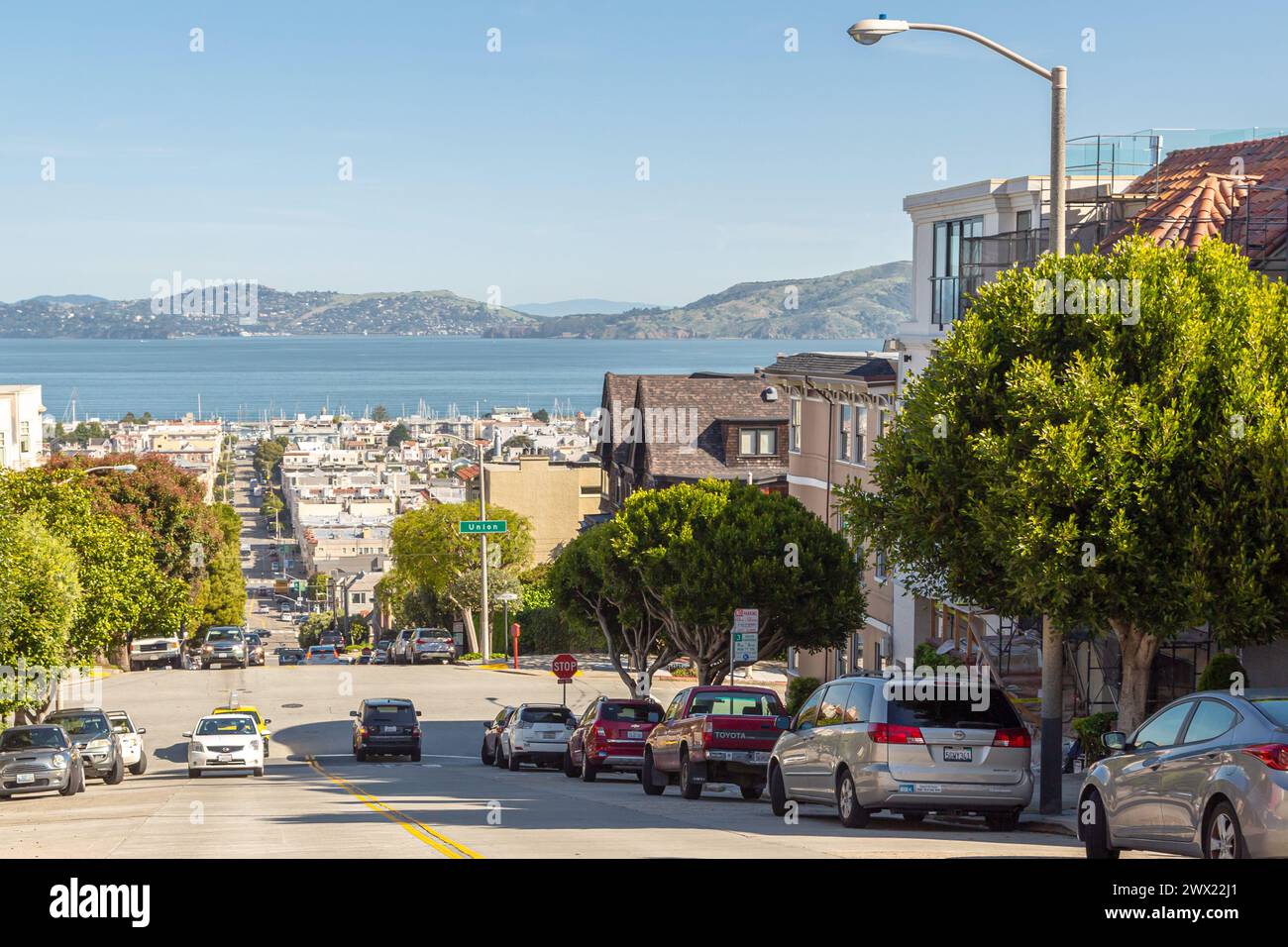 San Francisco, California, USA - 22 April, 2017- Residential street leading down to Marina Boulevard in San Francisco. Residential area on hills in San Francisco. View of the bay from the hill Stock Photo