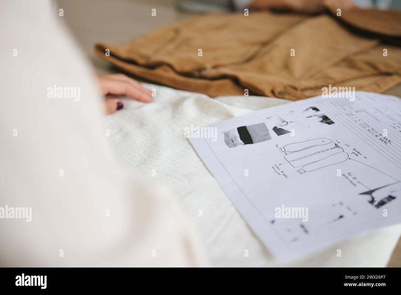 Woman selecting fabrics in clothing manufacturing process. Fitting room, textile industry Stock Photo