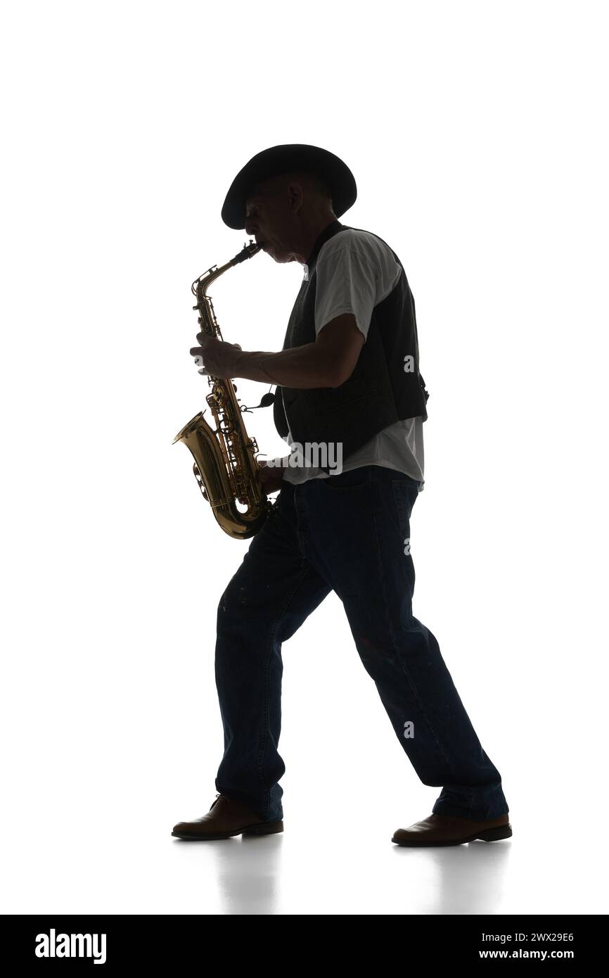 Silhouette of man in classical suit playing saxophone isolated on white background. Black and white image. Stock Photo