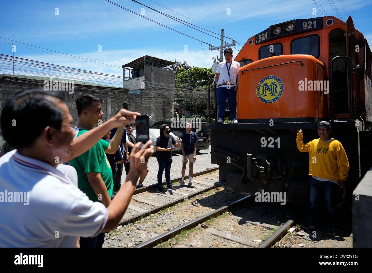 Train In Ph Passengers pose for pictures beside a Philippine National Railway train ...