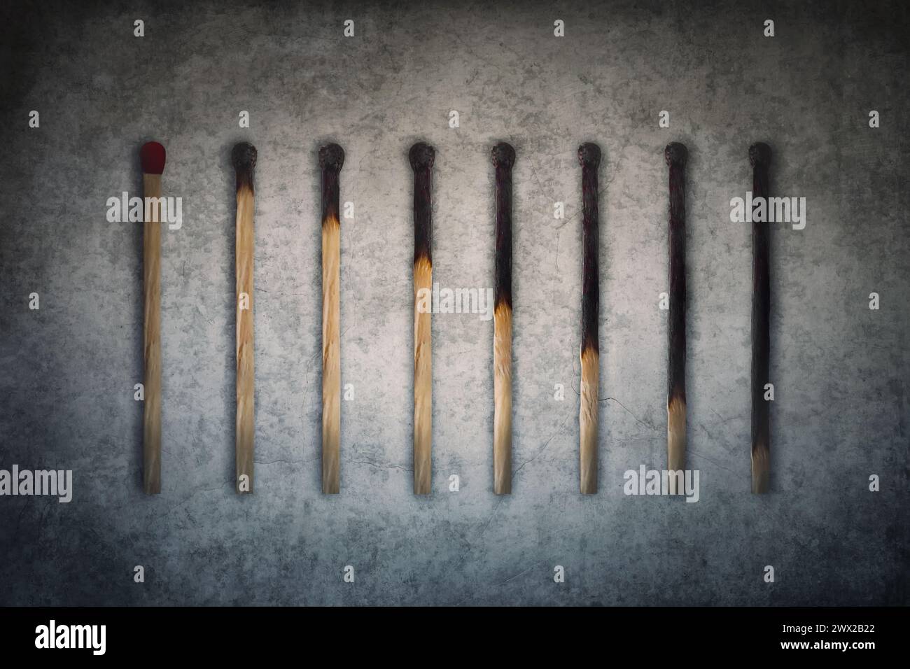 Match sticks burnt at different stages arranged in shape of a decreasing graph or chart. Business decrease conceptual background Stock Photo