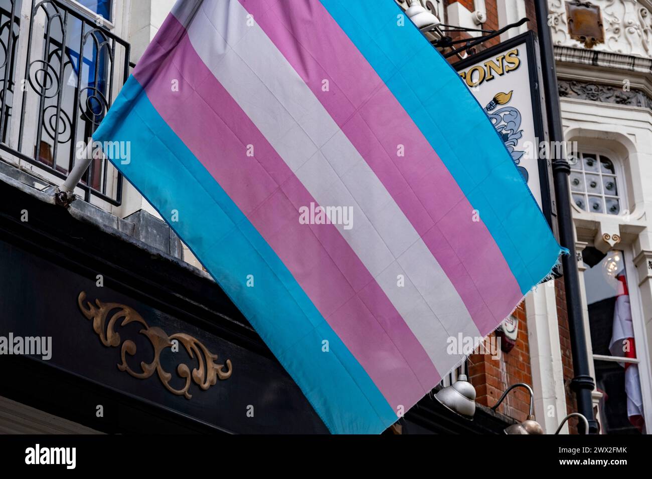 Transgender Pride flag in Soho on 6th March 2024 in London, United Kingdom. The transgender flag is a light blue, pink and white pentacolour pride flag representing the transgender community, organizations, and individuals. Stock Photo