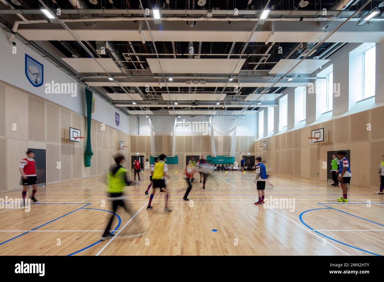 Main hall being used for football. Fulham Boys School, Fulham, United Kingdom. Architect: Architecture Initiative, 2021. Stock Photo