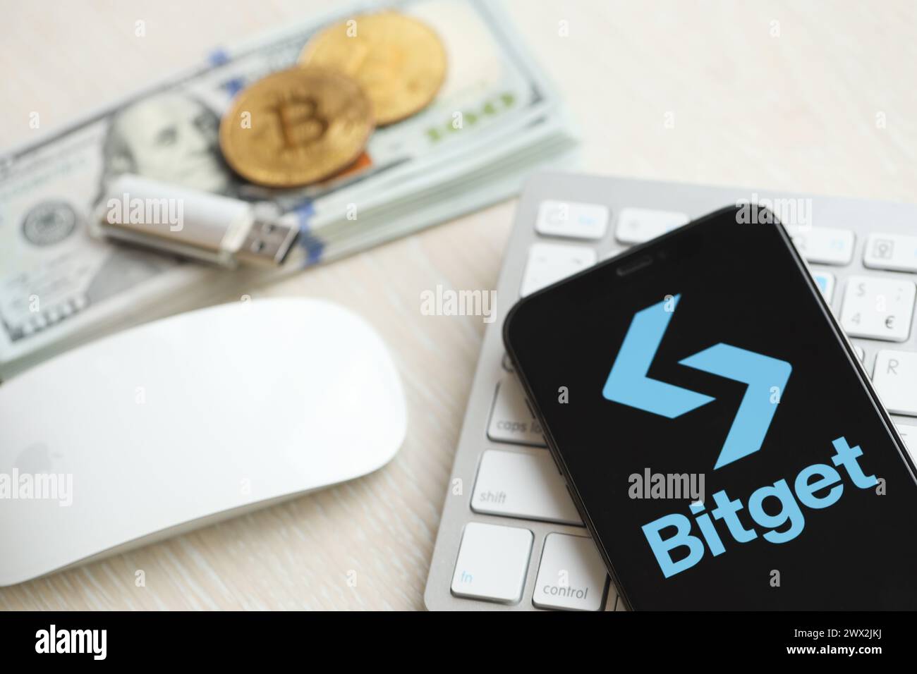 KYIV, UKRAINE - MARCH 15, 2024 Bitget logo on iPhone display screen on  white keyboard with money and bitcoins. Cryptocurrency exchange portal  Stock Photo - Alamy