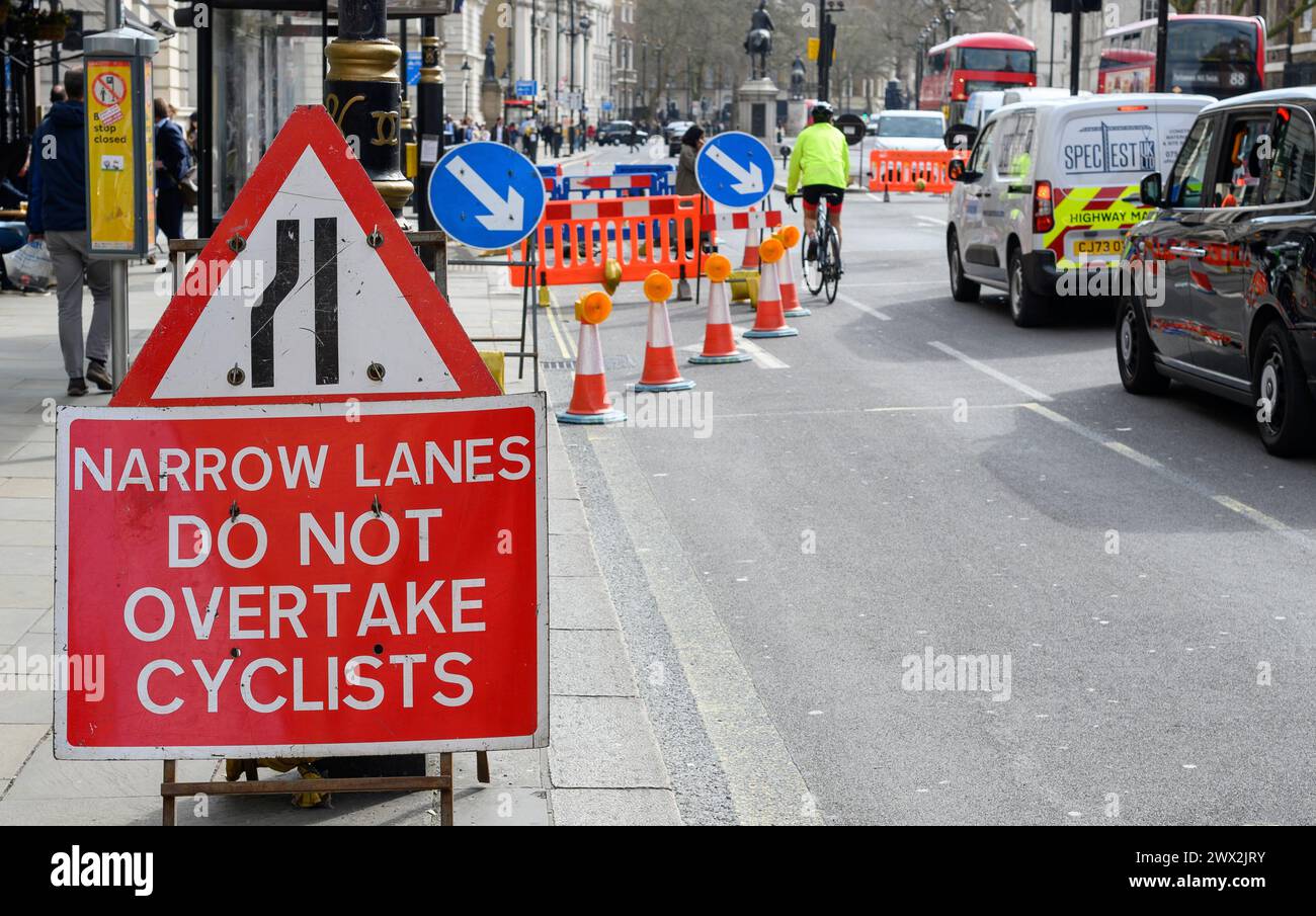 London, UK. Traffic sign in Whtiehall, Westminster, warning not to overtake bicycles. Stock Photo