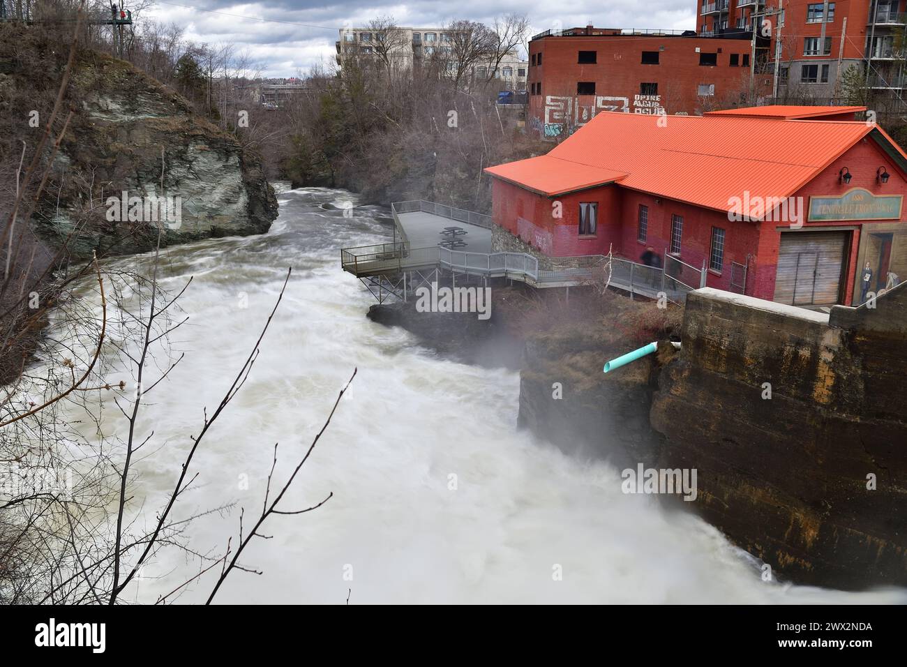 SHERBROOKE, QUEBEC, CANADA - April 16, 2022: Magog river rushing water Frontenac hydroelectric power plant early spring Stock Photo