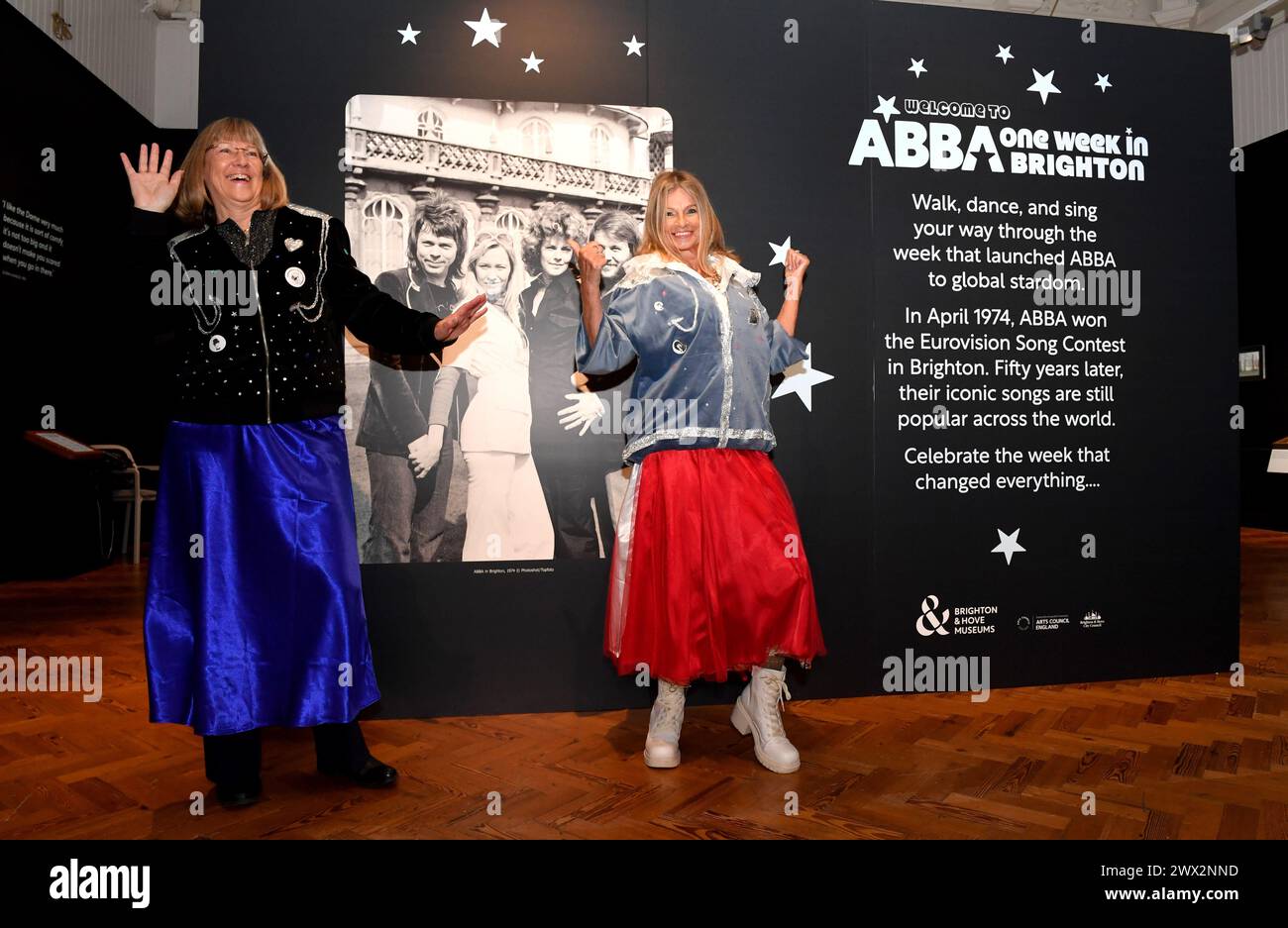 Brighton UK 27th March 2024 -  Dressed for the occasion sisters Jacqui and Janet O'Byrne look around the ABBA: One Week in Brighton exhibition press day at Brighton Museum celebrating fifty years since they won the Eurovision Song Contest . The exhibition opens to the public tomorrow Thursday 28th March : Credit Simon Dack / Alamy Live News Stock Photo