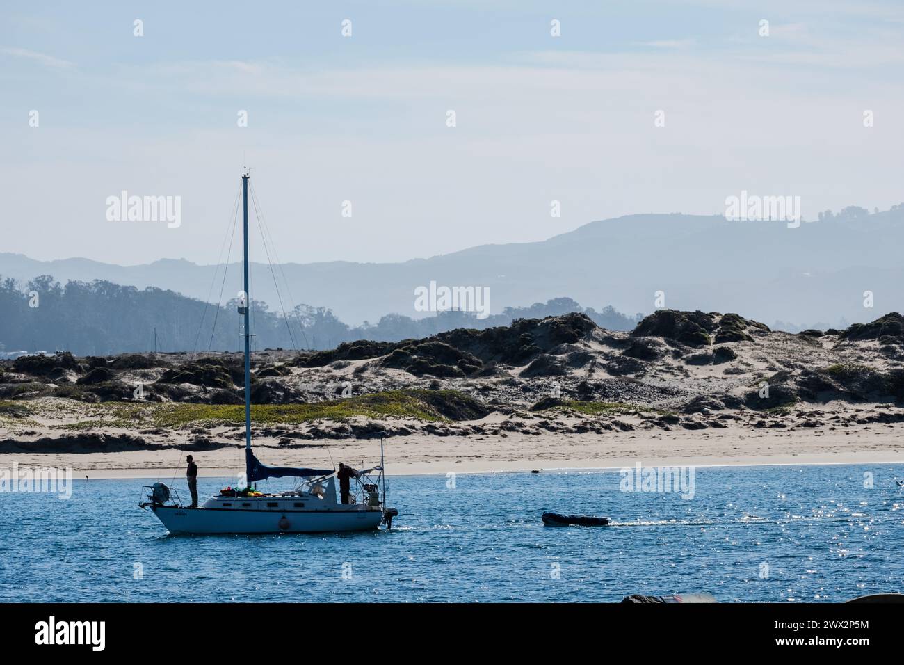 Sailboat at Morro Rock and Morro Bay, Pacific Ocean, Morro Bay, California, USA. Stock Photo