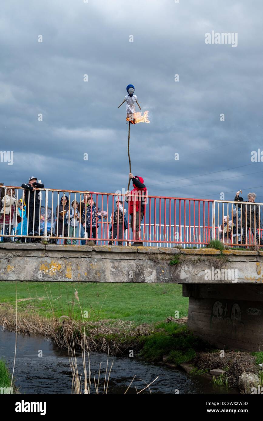 Traditional Slavic Morena effigy burning ritual on bridge with crowd ...