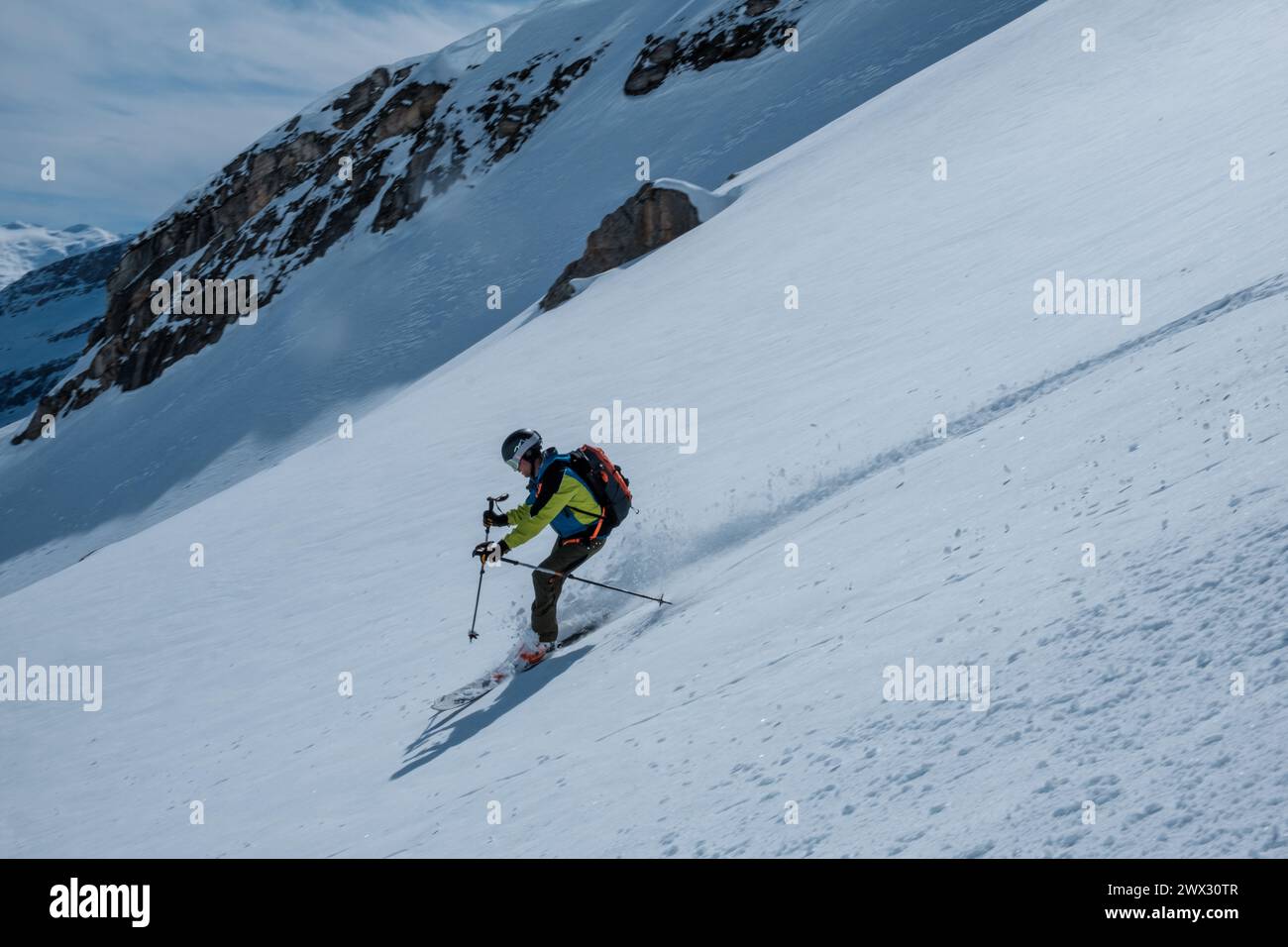 skier on ski tour downhill in powder snow Stock Photo