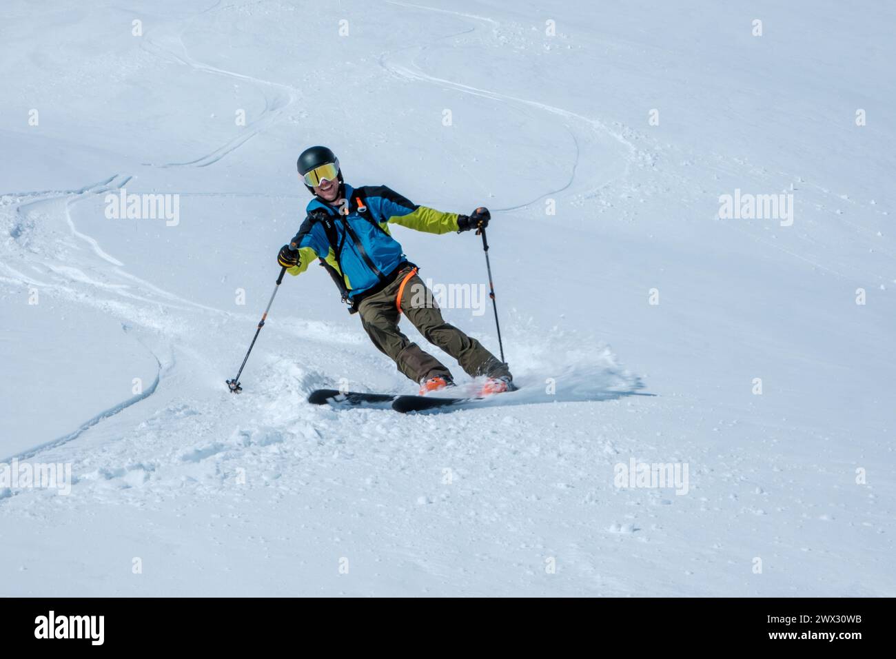 skier on ski tour downhill in powder snow Stock Photo