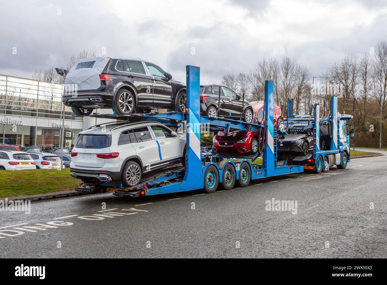 Loaded ECM HGV 7 car transporter   New model deliveries outside the Mercedes Benz showroom in Midland Way Preston, UK Stock Photo