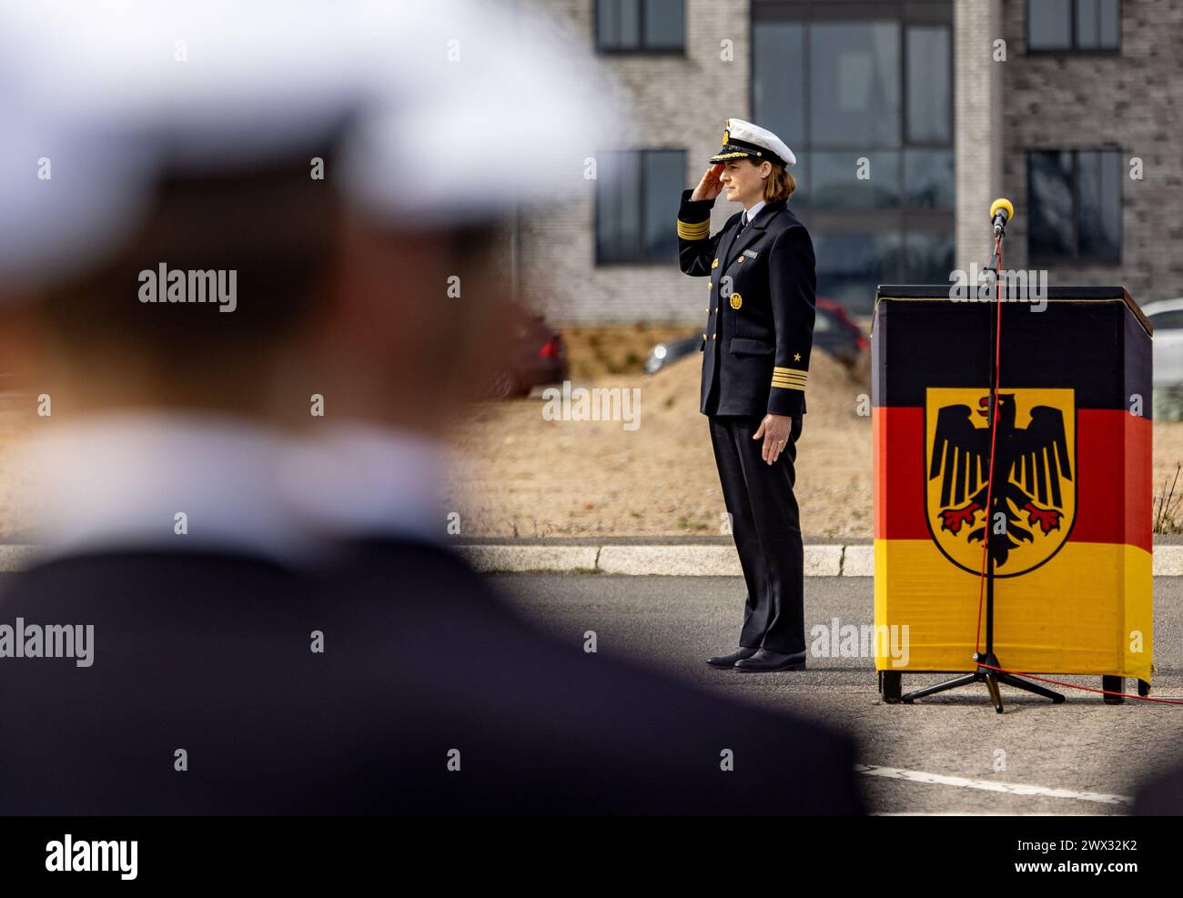 Kiel, Germany. 27th Mar, 2024. Frigate Captain Inka von Puttkamer salutes as she hands over command of the 3rd Minesweeper Squadron. Von Puttkamer is the first woman to take command of a German Navy combat unit. Credit: Axel Heimken/dpa/Alamy Live News Stock Photo
