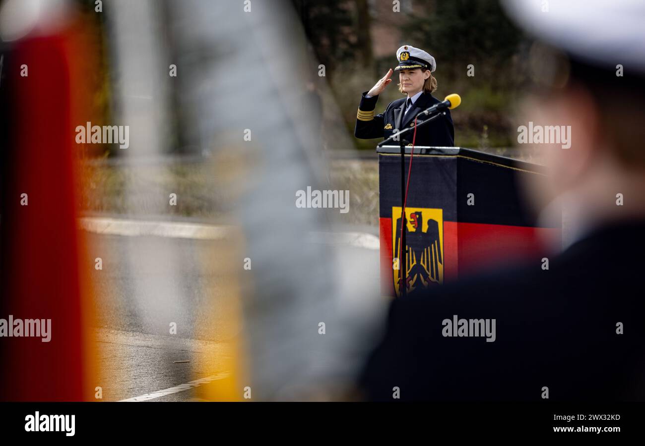 Kiel, Germany. 27th Mar, 2024. Frigate Captain Inka von Puttkamer salutes as she hands over command of the 3rd Minesweeper Squadron. Von Puttkamer is the first woman to take command of a German Navy combat unit. Credit: Axel Heimken/dpa/Alamy Live News Stock Photo