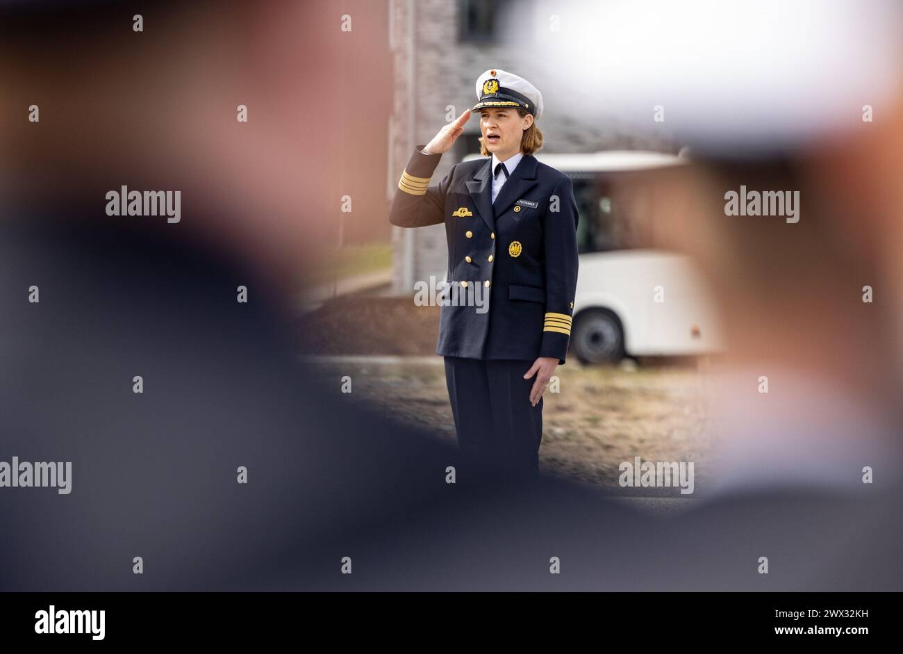 Kiel, Germany. 27th Mar, 2024. Frigate Captain Inka von Puttkamer salutes as she hands over command of the 3rd Minesweeper Squadron. Von Puttkamer is the first woman to take command of a German Navy combat unit. Credit: Axel Heimken/dpa/Alamy Live News Stock Photo