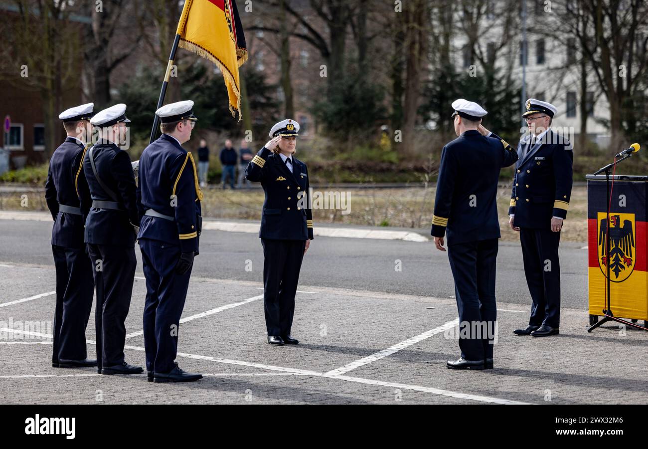 Kiel, Germany. 27th Mar, 2024. Frigate Captain Inka von Puttkamer salutes as she hands over command of the 3rd Minesweeper Squadron. Von Puttkamer is the first woman to take command of a German Navy combat unit. Credit: Axel Heimken/dpa/Alamy Live News Stock Photo
