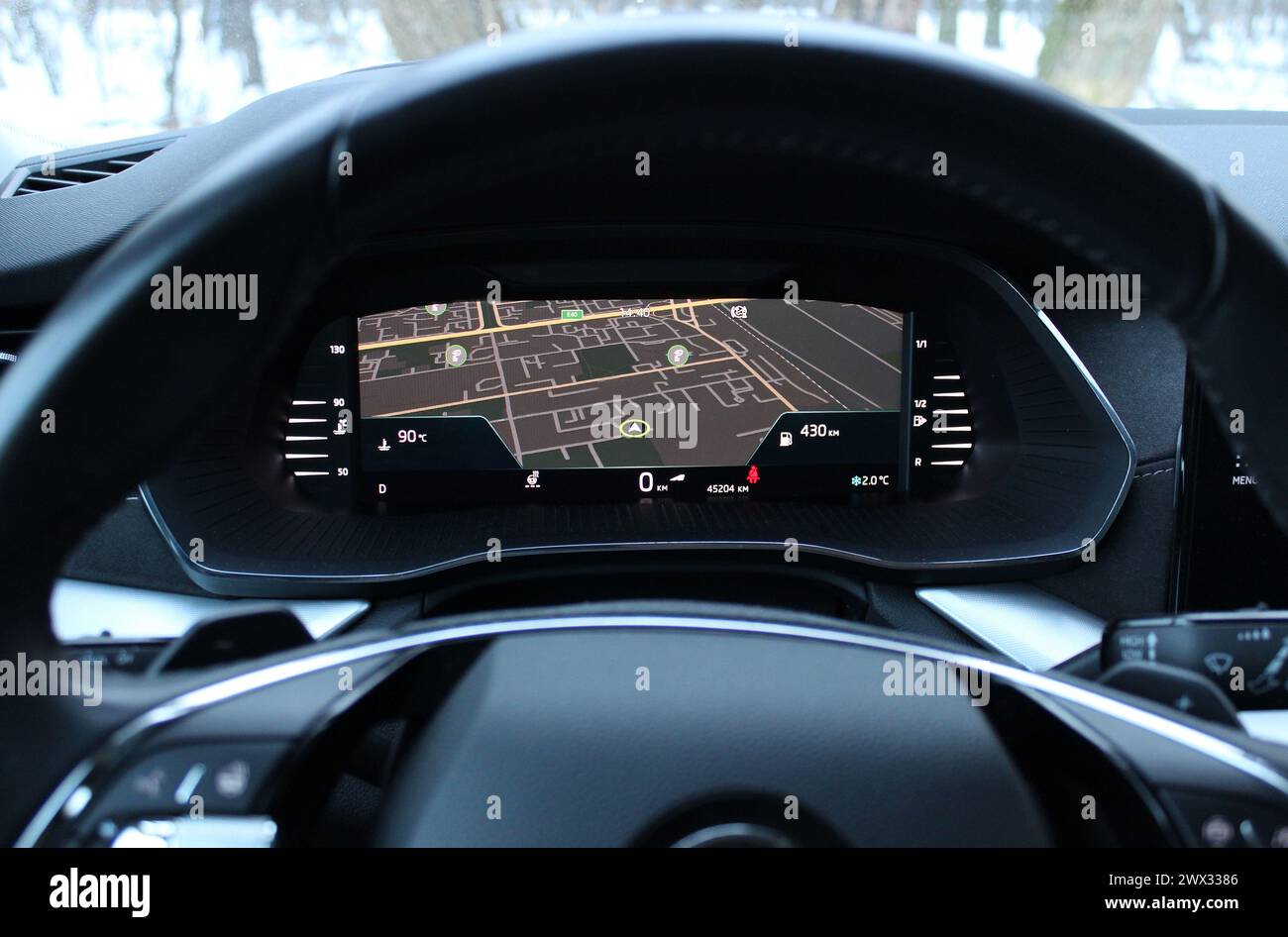 View of the car navigation display with city map through the steering ...