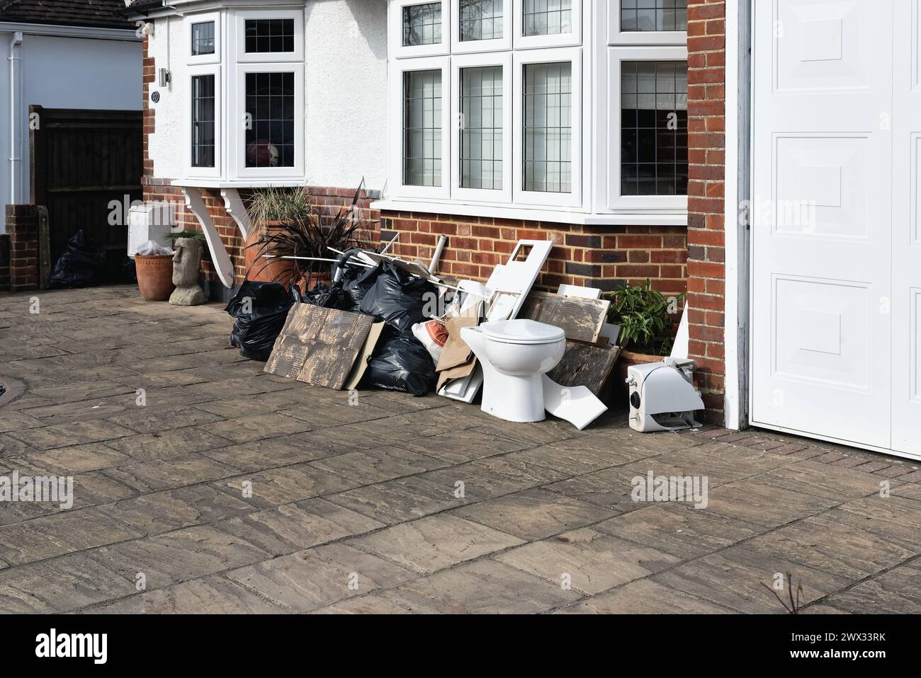 Household building waste piled outside a private home in Shepperton Surrey England UK Stock Photo
