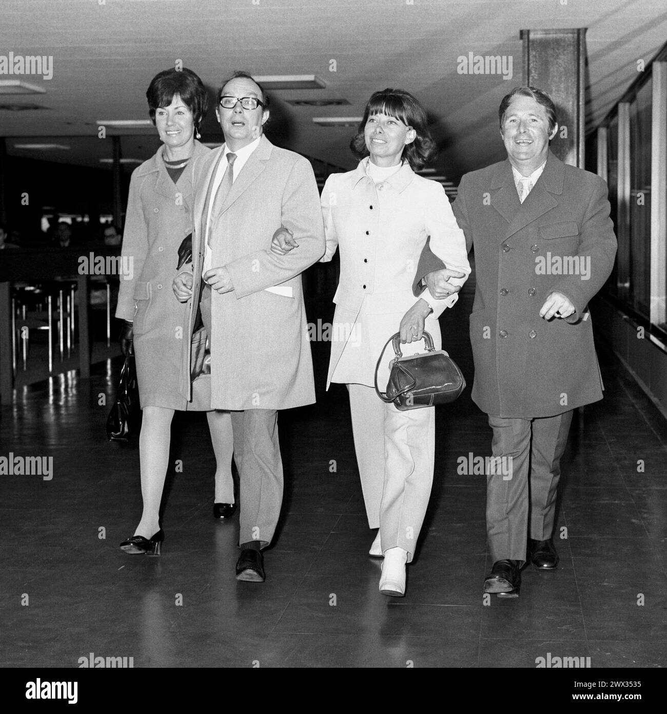 File photo dated 26/04/70 of comedians Eric Morecambe (second left) and Ernie Wise, accompanied by their wives Joan Morecambe (left) and Doreen Wise, at Heathrow Airport before flying out to the Montreau Festival. Eric Morecambe's widow Joan has died 'peacefully' on her 97th birthday following a short illness, her family has announced. She married the famed comedian, known for his double act Morecambe and Wise alongside Ernie Wise, in Margate in 1952. Issue date: Wednesday March 27, 2024. Stock Photo
