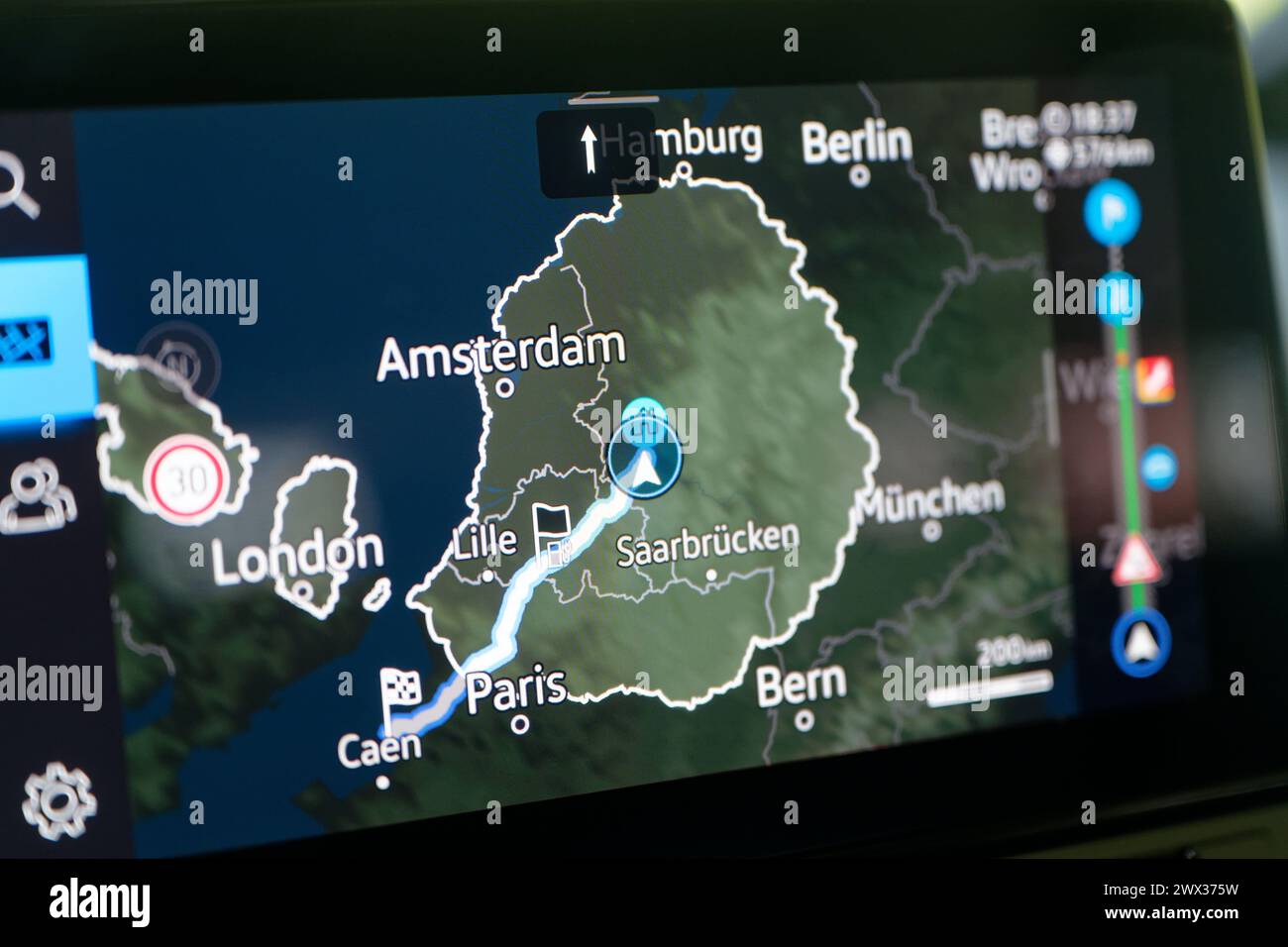 Cologne, Germany. 25th Mar, 2024. The navigation screen of an electric car shows the route and the necessary charging stops for a long-distance journey with an electric car. Credit: Henning Kaiser/dpa/Alamy Live News Stock Photo