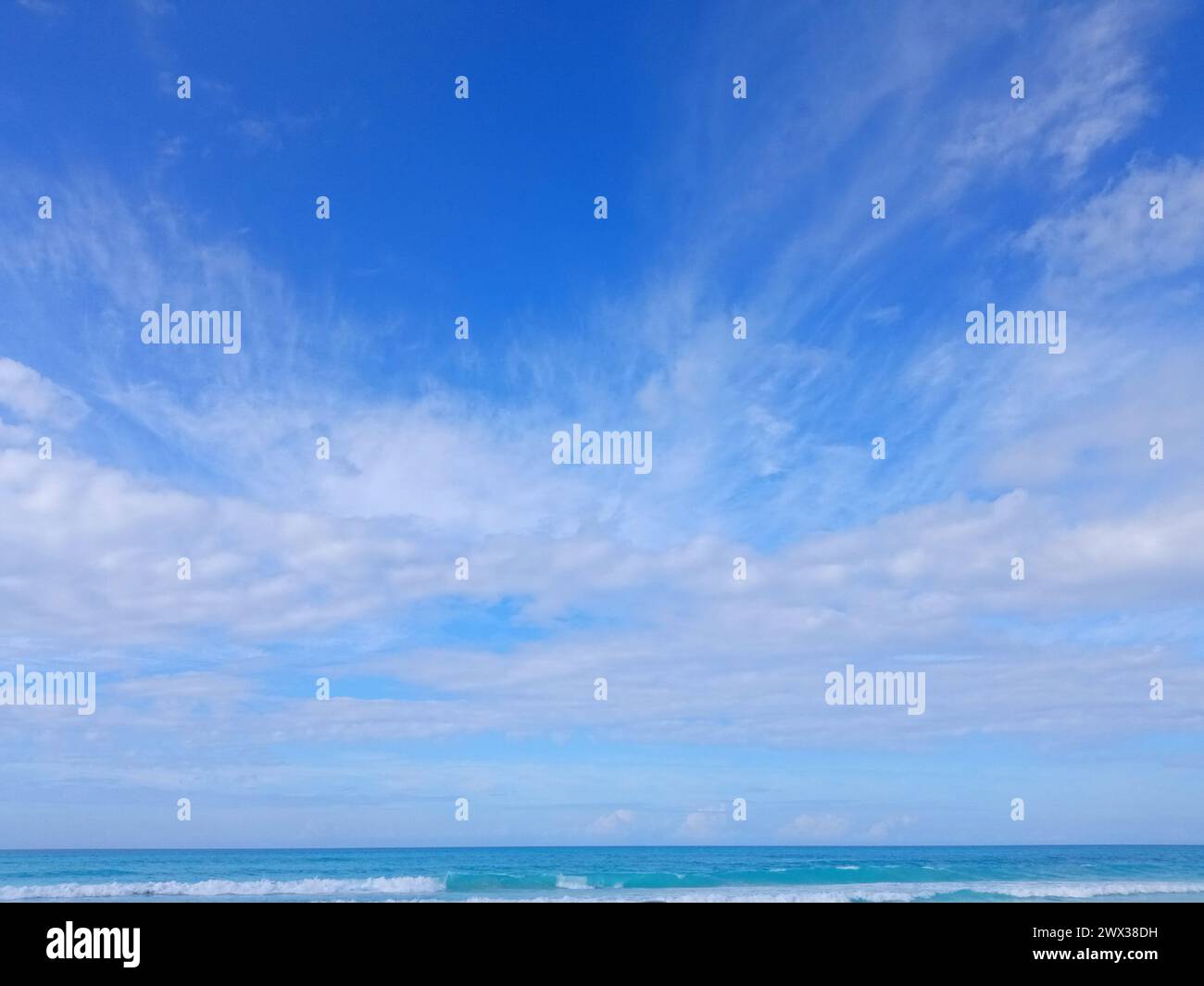 Blue sky with clouds over beach hi-res stock photography and images - Alamy