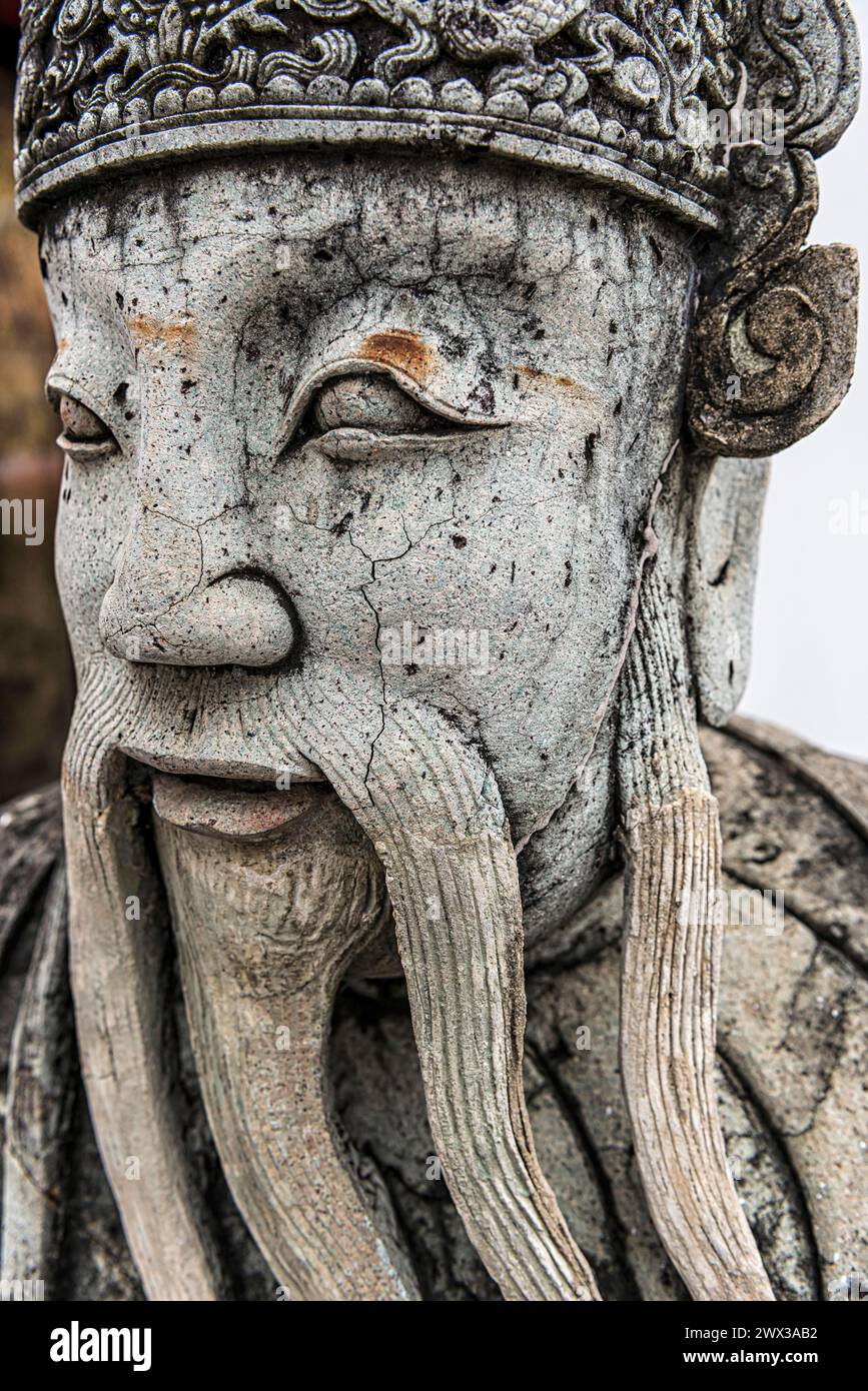 Stone sculpture in Wat Pho temple, head, face, weathered, Buddhism, religion, world religion, sculpture, sculpting, art, statue, garden, culture Stock Photo