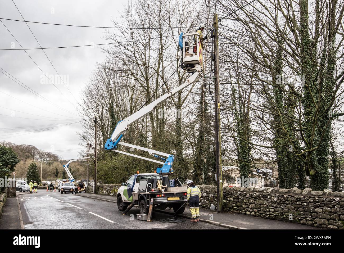 Replacement of overhead cables  as part pf power network maintenance requiring a team of skilled personnel. Stock Photo
