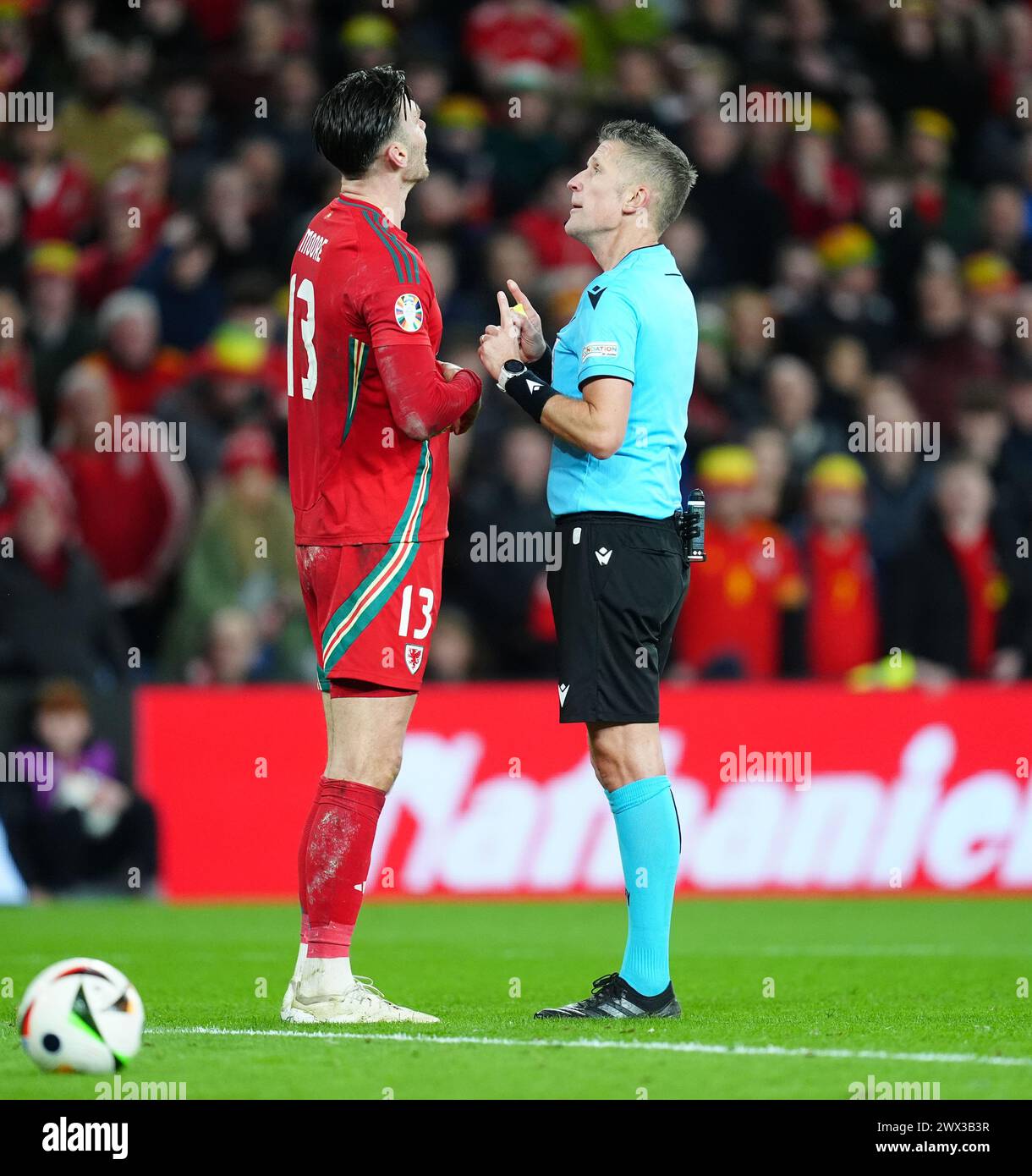 Referee Daniele Orsato with Wales' Kieffer Moore during the UEFA Euro 2024 Qualifying play-off final at the Cardiff City Stadium, Wales. Picture date: Tuesday March 26, 2024. Stock Photo