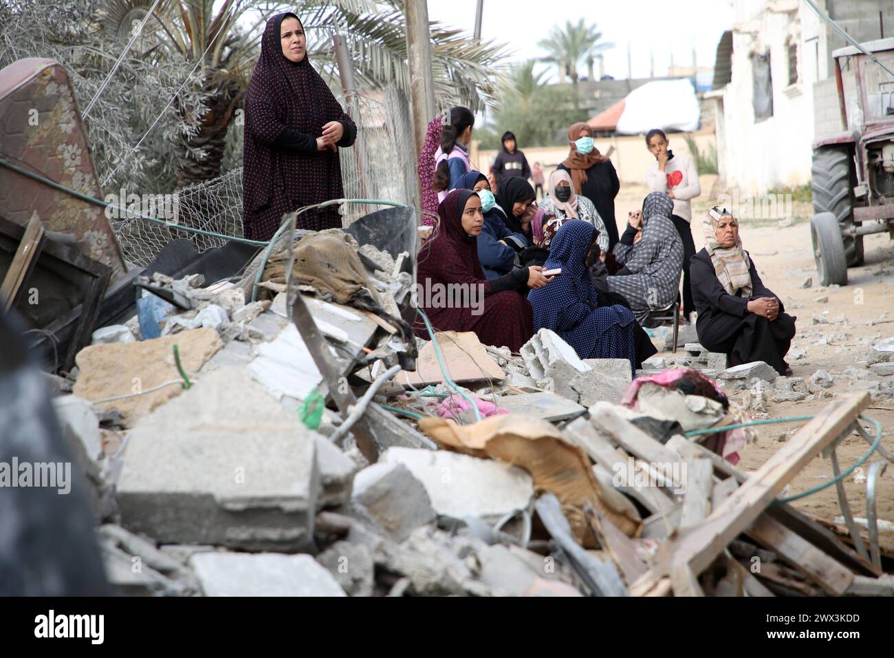 Palestinians gather to inspect damage of the destroyed building ...
