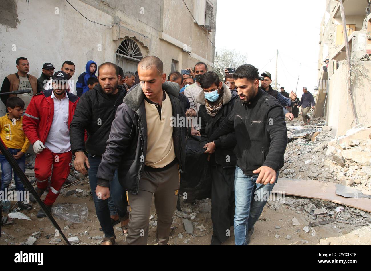 Palestinians gather to inspect damage of the destroyed building ...