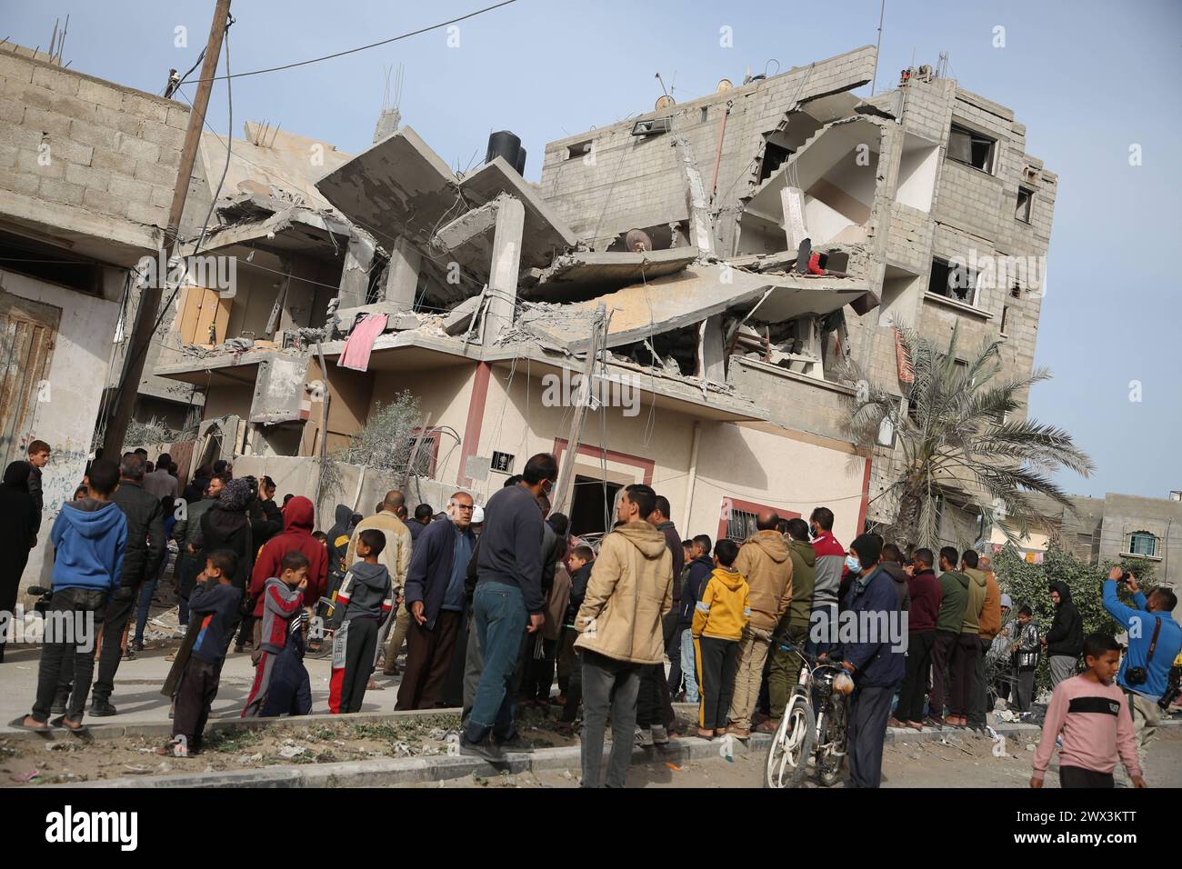 Palestinians gather to inspect damage of the destroyed building ...