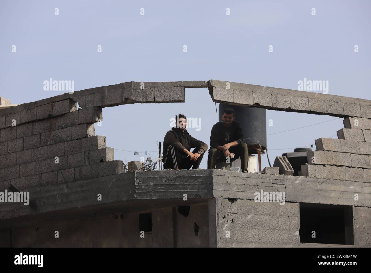 Palestinians gather to inspect damage of the destroyed building ...