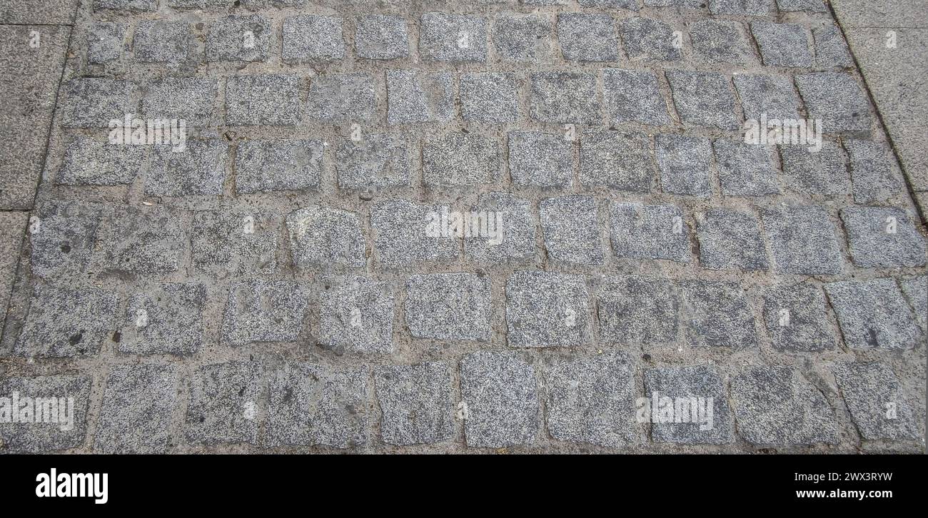 Sett pavement made with quarried granite cubic blocks without roughing. Monumental Complex road surfaces, Caceres, Spain Stock Photo