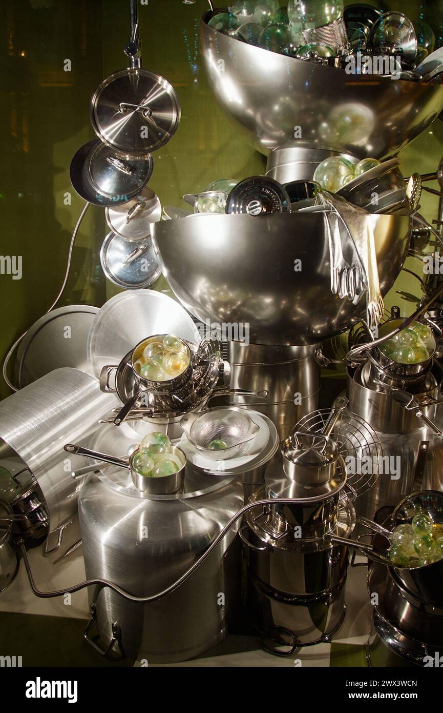 Shop Window Display Of Stainless Steel Kitchen Utensils, Pots And Pans Piled Up Together, London UK Stock Photo
