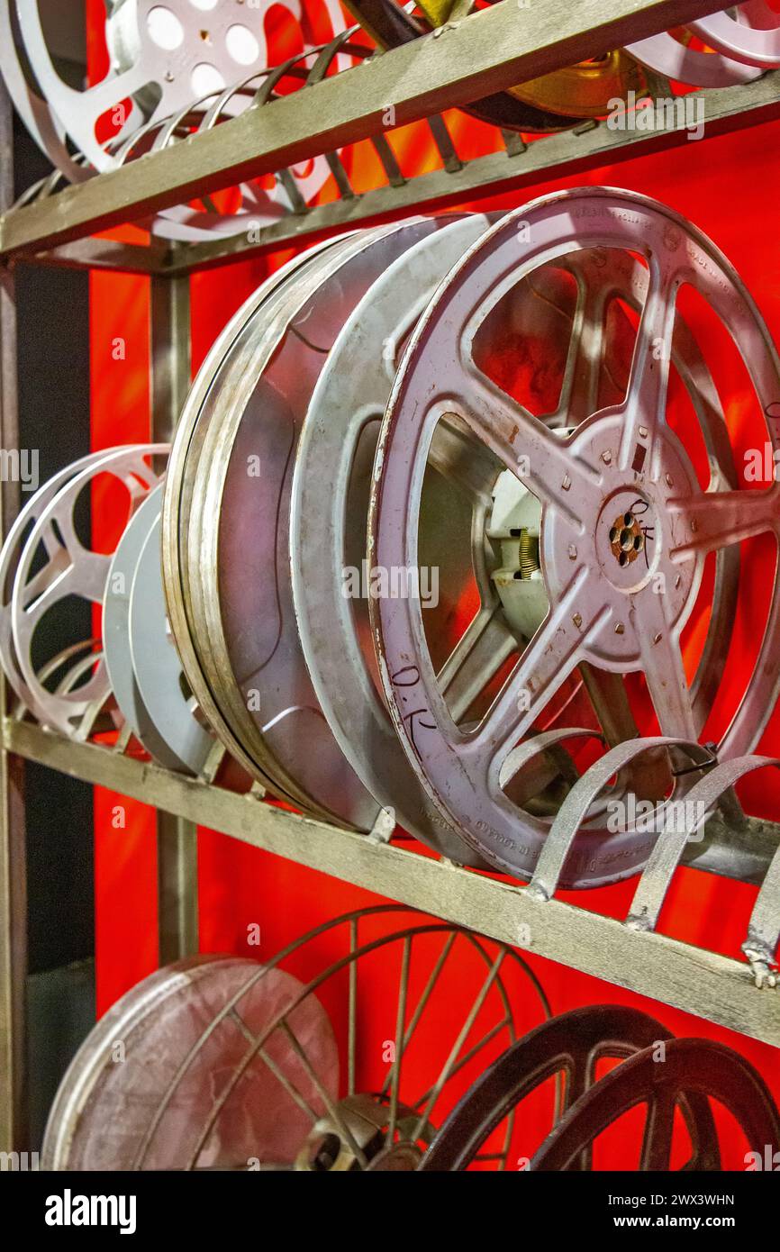 Original old big movie reel for 35 mm cinema projector loaded with film in  vintage color effect on neutral background Stock Photo - Alamy