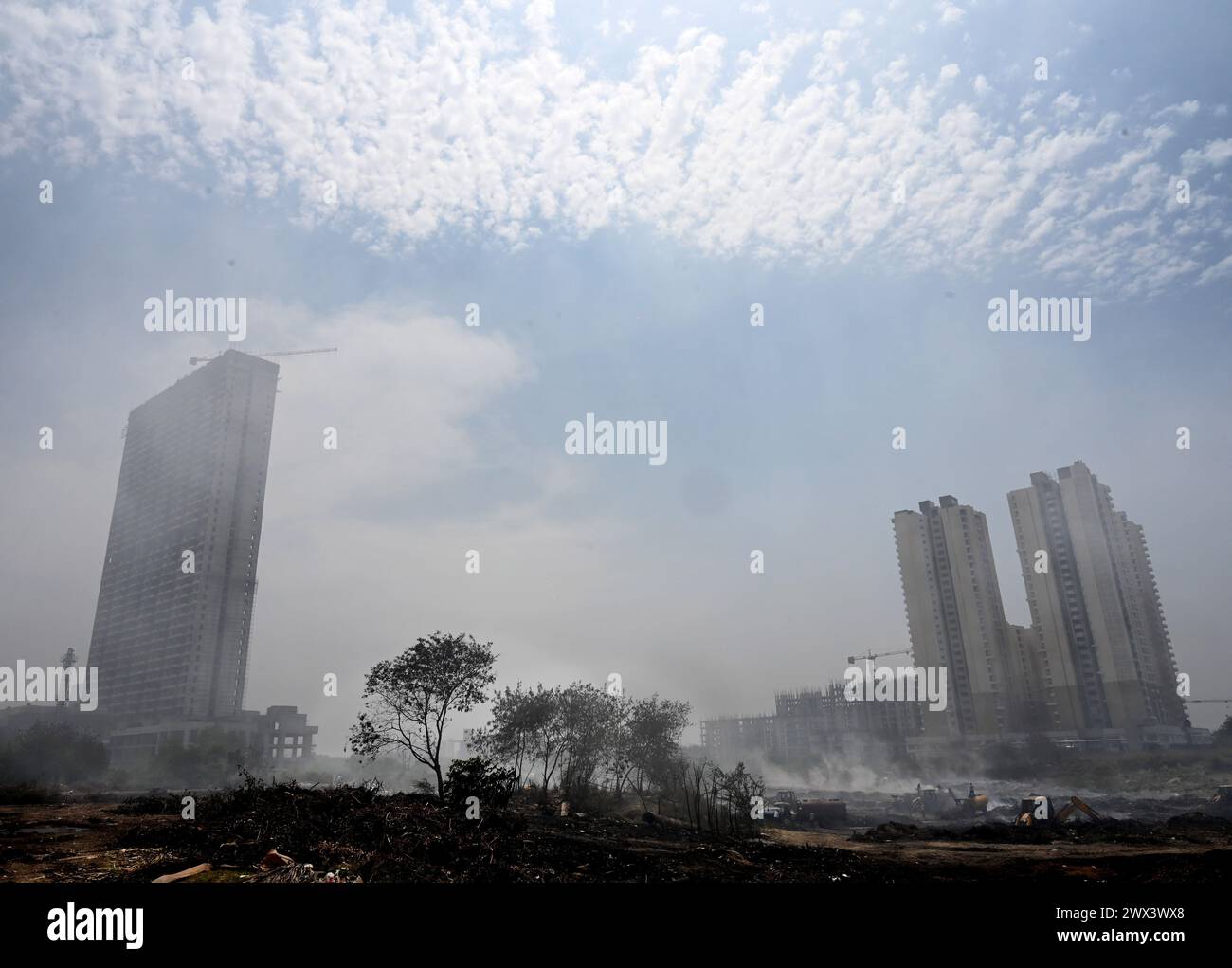 Noida, India. 27th Mar, 2024. NOIDA, INDIA - MARCH 27: Firefighters try to douse a fire at horticulture waste dumping yard in Sector 32 on March 27, 2024 in Noida, India. The fire started around 6pm on Monday and has engulfed an area roughly 1.5km wide and 2km long in Sector 32, GB Nagar fire chief said. All horticulture waste from across Noida is dumped at that plot for conversion into compost. (Photo by Sunil Ghosh/Hindustan Times/Sipa USA) Credit: Sipa USA/Alamy Live News Stock Photo