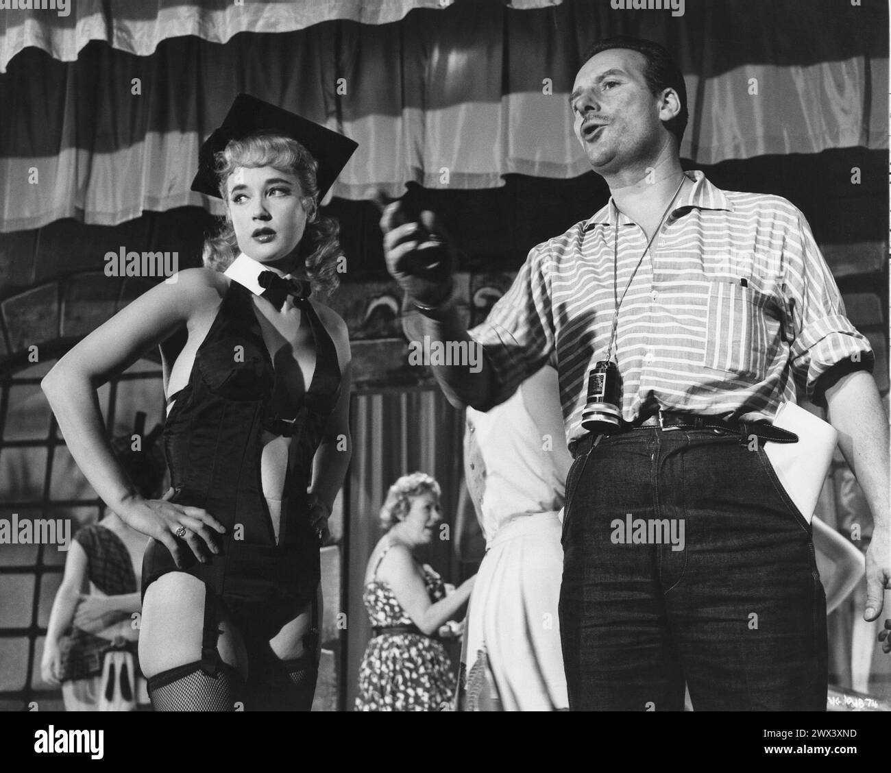 British actress SYLVIA SYMS with director / producer VAL GUEST getting ready to film a scene for EXPRESSO BONGO 1959 also starring LAURENCE HARVEY, YOLANDE DONLAN and CLIFF RICHARD From the stage play by WOLF MANKOWITZ and JULIAN MORE Costume Design BEATRICE DAWSON British Lion Films Stock Photo