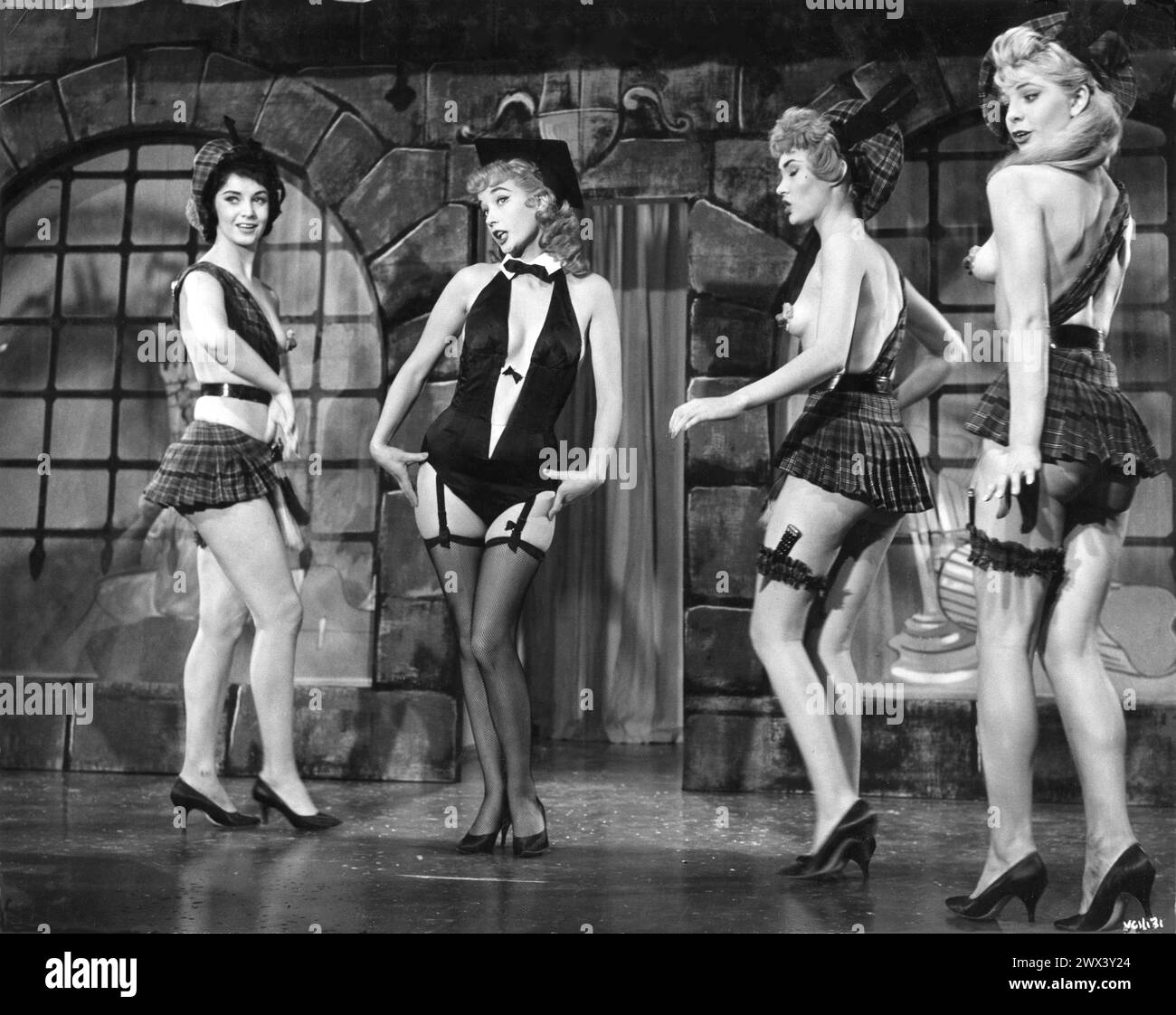SYLVIA SYMS and dancing girls in a scene from EXPRESSO BONGO 1959 also starring LAURENCE HARVEY, YOLANDE DONLAN and CLIFF RICHARD Produced and Directed by VAL GUEST From the stage play by WOLF MANKOWITZ  and JULIAN MORE Costume Design  BEATRICE DAWSON British Lion Films Stock Photo