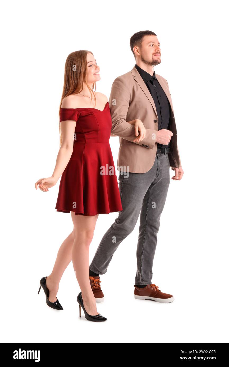 Elegant young couple walking hand in hand on white background Stock ...