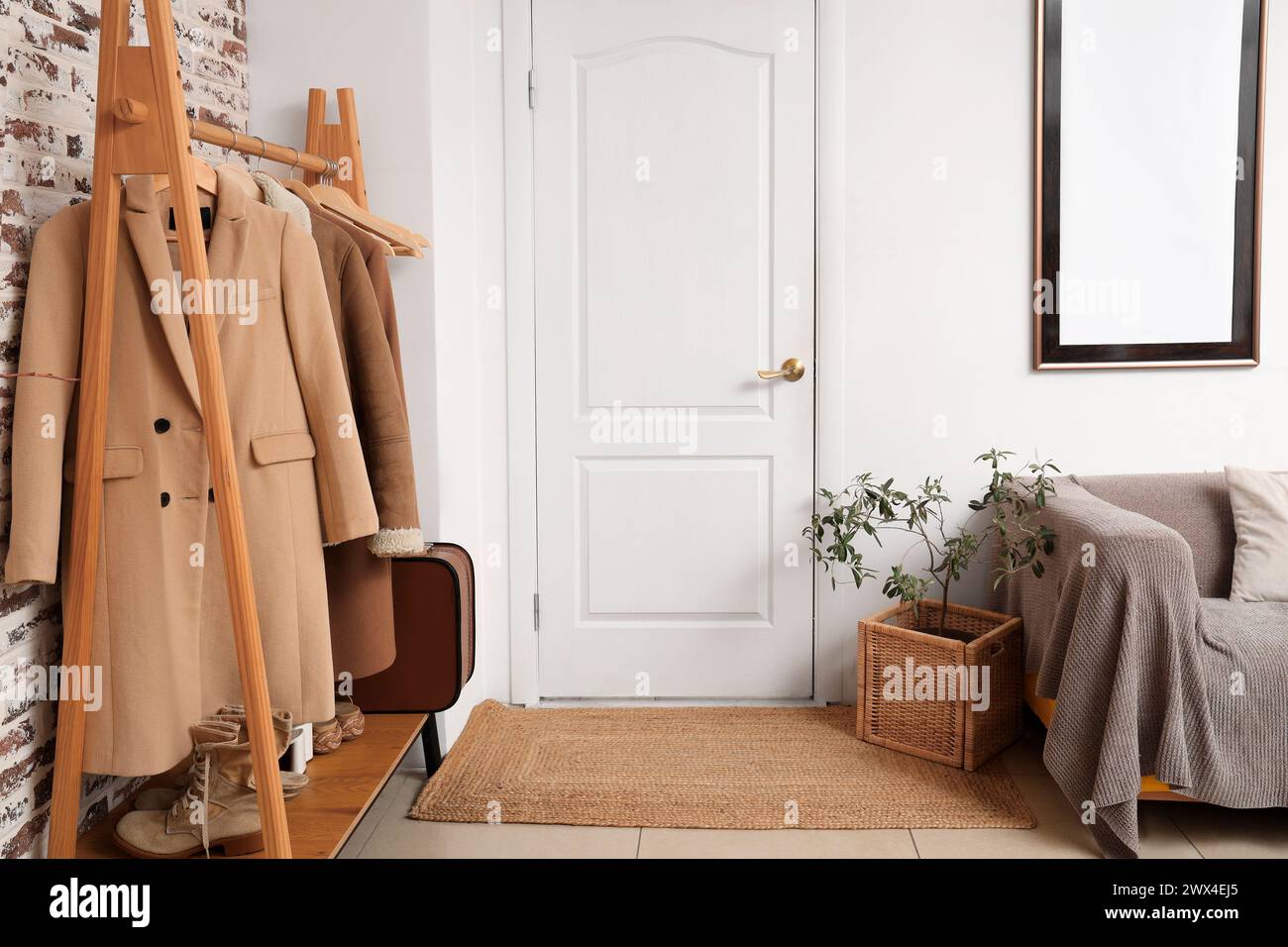 Interior of hall with white door and clothes rack Stock Photo - Alamy