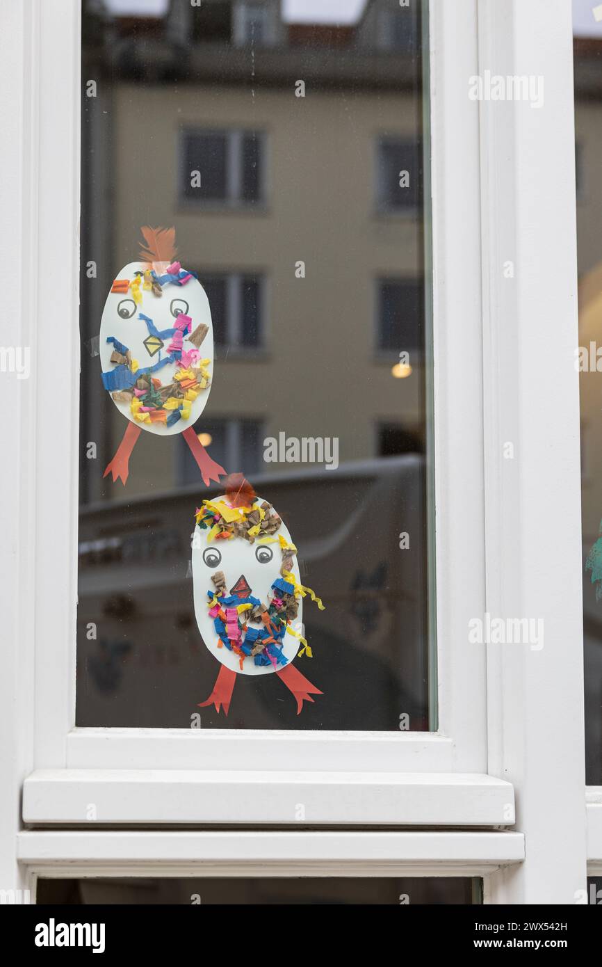 Easter motives on a window of a kindergarten. Walk through Schwabing on