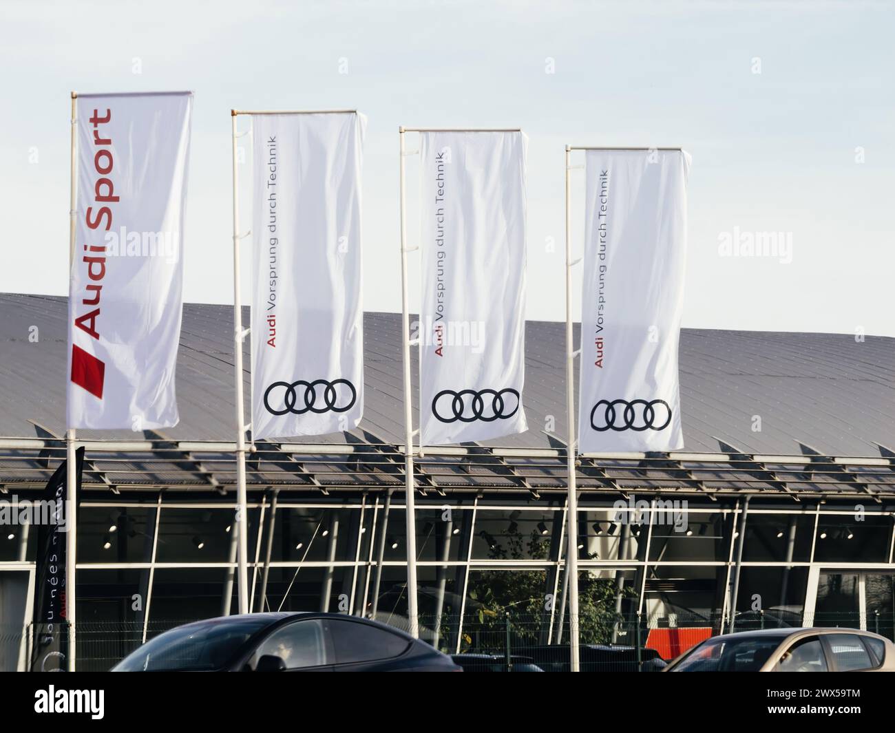 Strasbourg, France - Mar 20, 2024: Audi Sport flags flutter near a car ...