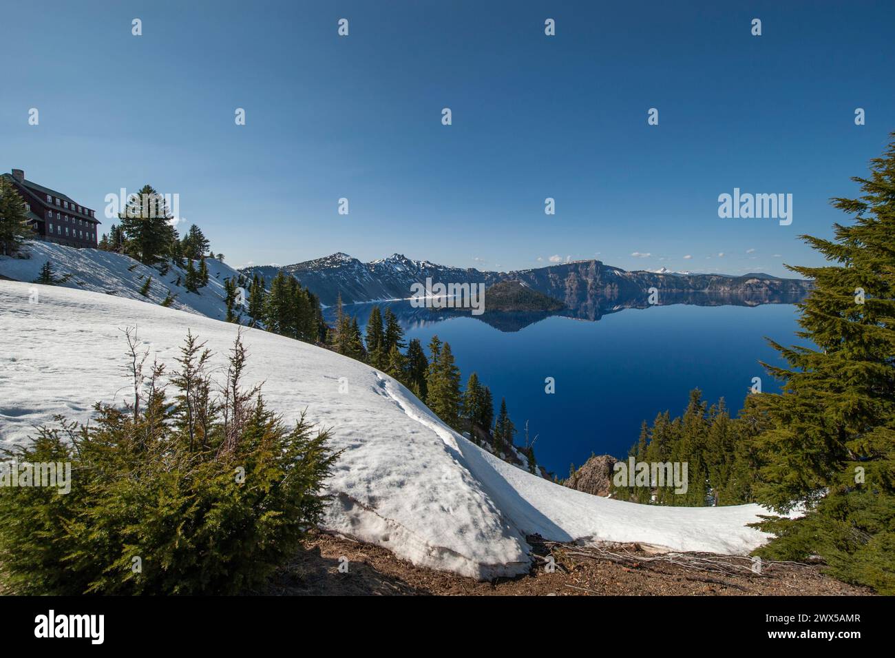 Crater Lake, Oregon in late spring.  The historic Lodge is in the upper left. Stock Photo