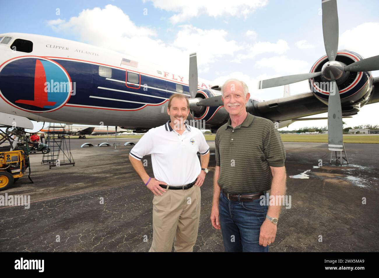 MIAMI, FL - NOVEMBER 17: Captain 'Sully' Sullenberger and Co-pilot Jeff Skiles pose with the Historical 1958 DC7 for a benefit hosted by Historical Flight Foundation. Chesley Burnett "Sully" Sullenberger, III (born January 23, 1951) is a retired airline captain and aviation safety consultant. He was hailed as a national hero in the United States when he successfully executed an emergency water landing of US Airways Flight 1549 in the Hudson River off Manhattan, New York City, after the aircraft was disabled by striking a flock of Canada geese during its initial climb out of LaGuardia Airport o Stock Photo