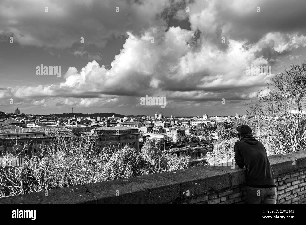 Silhouette of single man observing from above, Rome, capital city of Italy as seen from the Orange Garden, in black and white Stock Photo