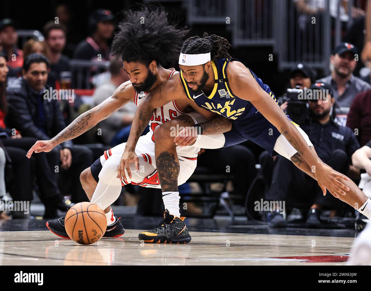 Chicago, USA. 27th Mar, 2024. Chicago Bulls' Coby White (L) vies with Indiana Pacers' Isaiah Jackson during the NBA regular season game between Indiana Pacers and Chicago Bulls in Chicago, the United States, March 27, 2024. Credit: Joel Lerner/Xinhua/Alamy Live News Stock Photo